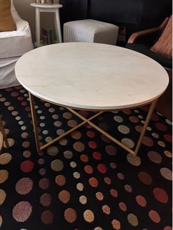 Round coffee table with gold medal base