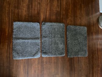 Tahari 3 Piece black and white bath rug set . Each rug measures Approx. 25” x 18”
