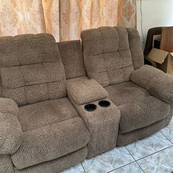 Ashley loveseat that reclines & has 2 drink holder & remote storage