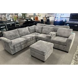 Light Gray corduroy sectional couch with ottoman USB console w/ cup holders
