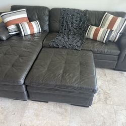 Used Black / Gray Leather Sectional Sofa with Storage Ottoman