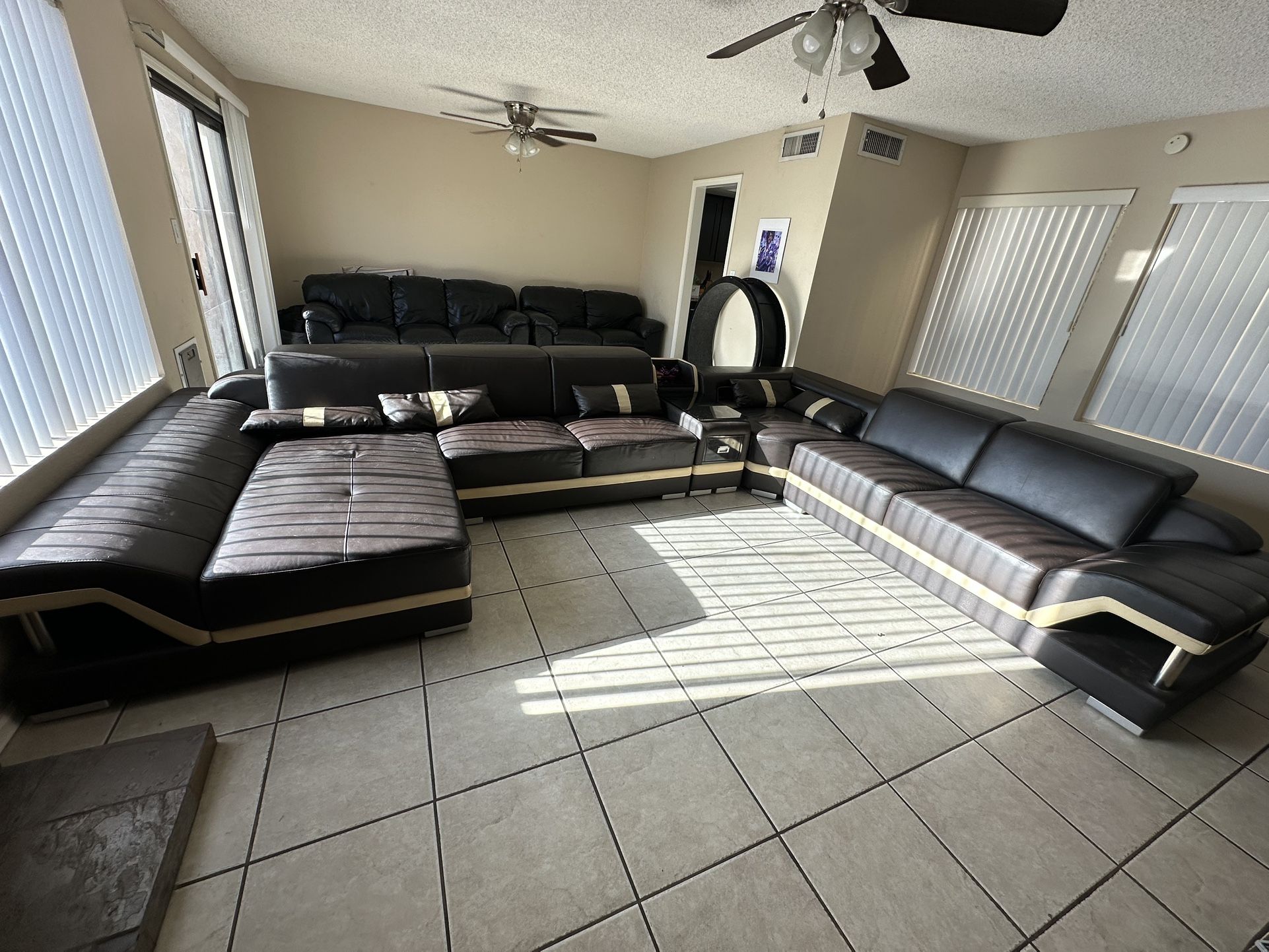 Three Piece Leather Couch, Table, And Entertainment Center Set