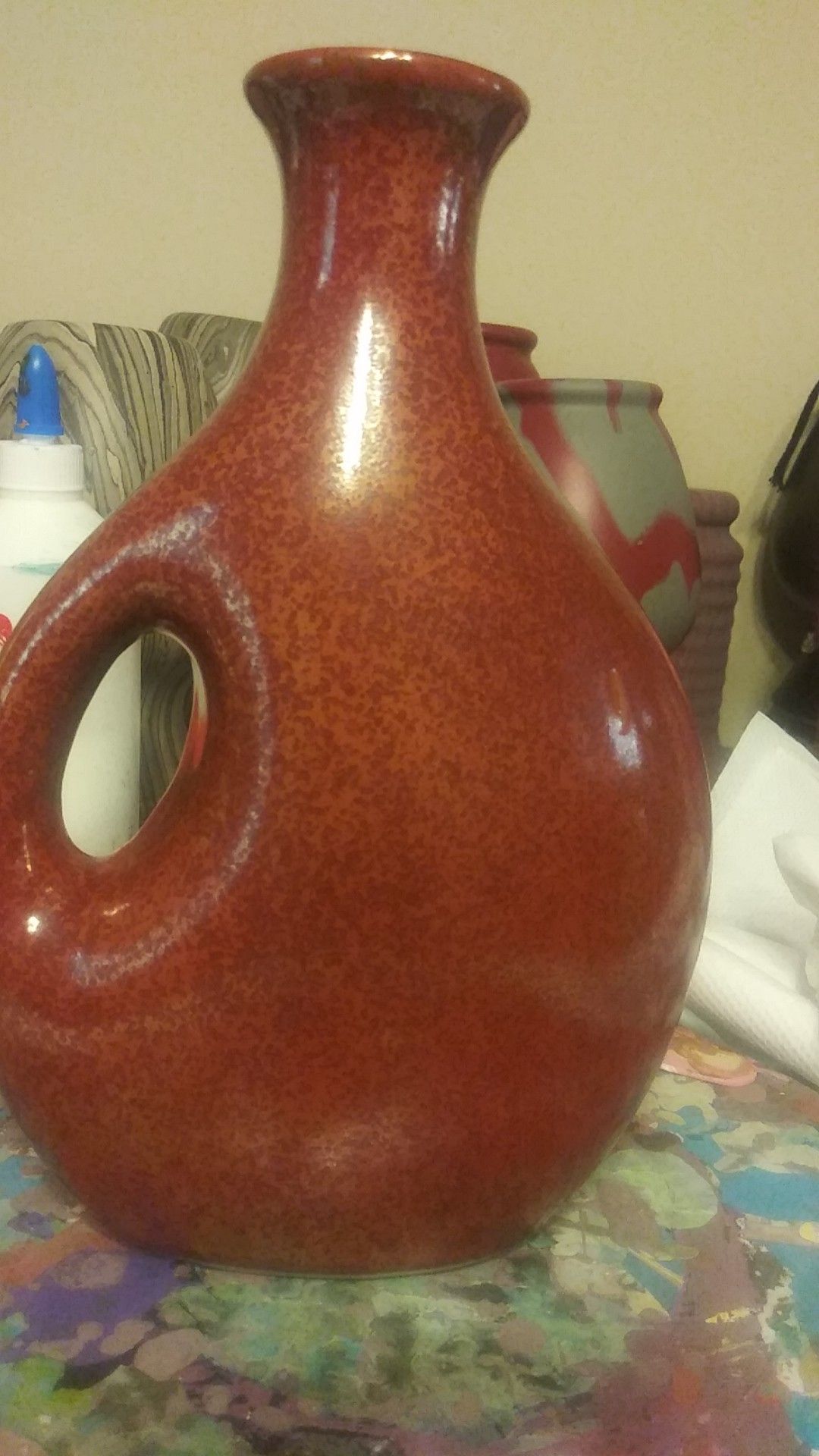 Beautiful rustic odd shaped vase with handle. A rust colored reddish orange vase for Sale in