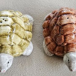 Add a touch of whimsy to your kitchen with these adorable turtle-shaped salt and pepper shakers. Crafted from high-quality porcelain, these shakers ar