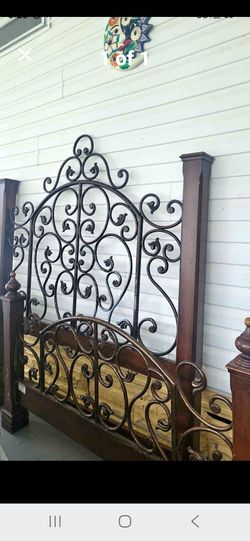 Vintage queen bed set, ornate scroll wrought iron with solid wood posts. Includes headboard + footboard only. Good used condition, minor wear. Sturdy.