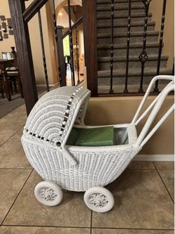 Small white wicker baby carriage