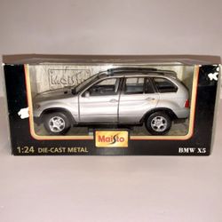 Maisto Special Edition BMW X5 – 1:24 Scale Die-Cast Model  Beautiful silver BMW X5 SUV in 1:24 scale by Maisto. Detailed die-cast metal body with real