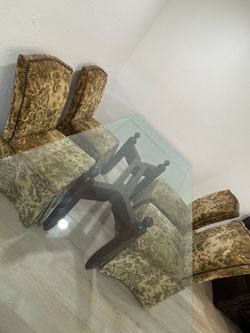 Heavy glass dinning table with four chairs.