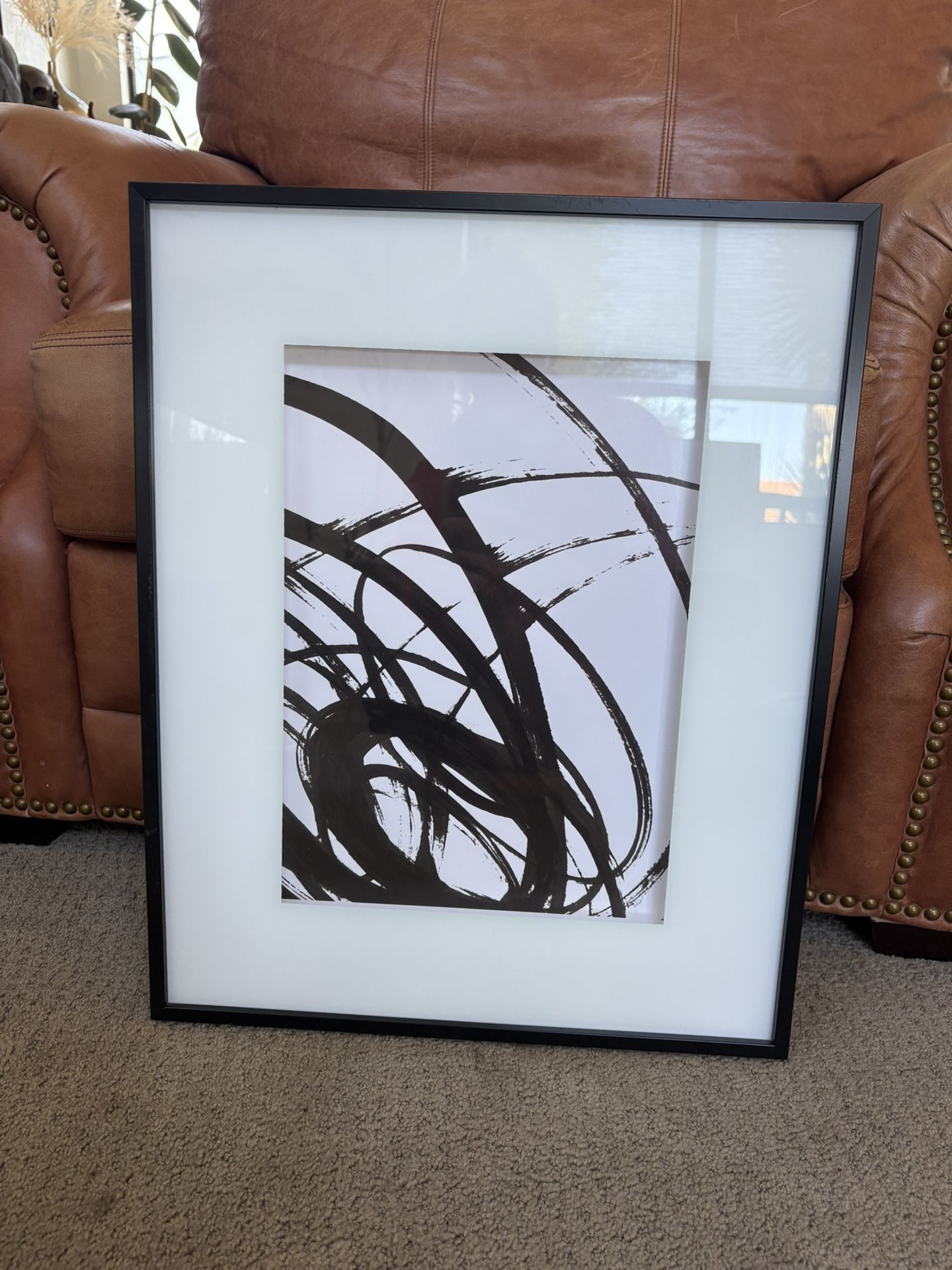 Black and white print, black framed glass.