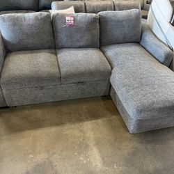 Large gray sectional with chaise 🤍 Spacious, comfortable, and perfect for a family living room. Includes a pull-out section for extra lounging space.