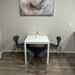 White Table and 3 Gray Chairs