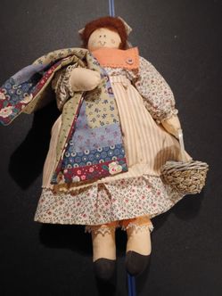 Handmade cloth rag doll with basket