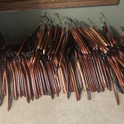 Over 80 wooden hangers 