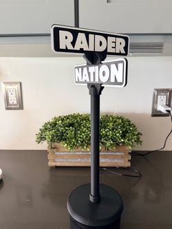 Street sign displays NFL Basketball Baseball