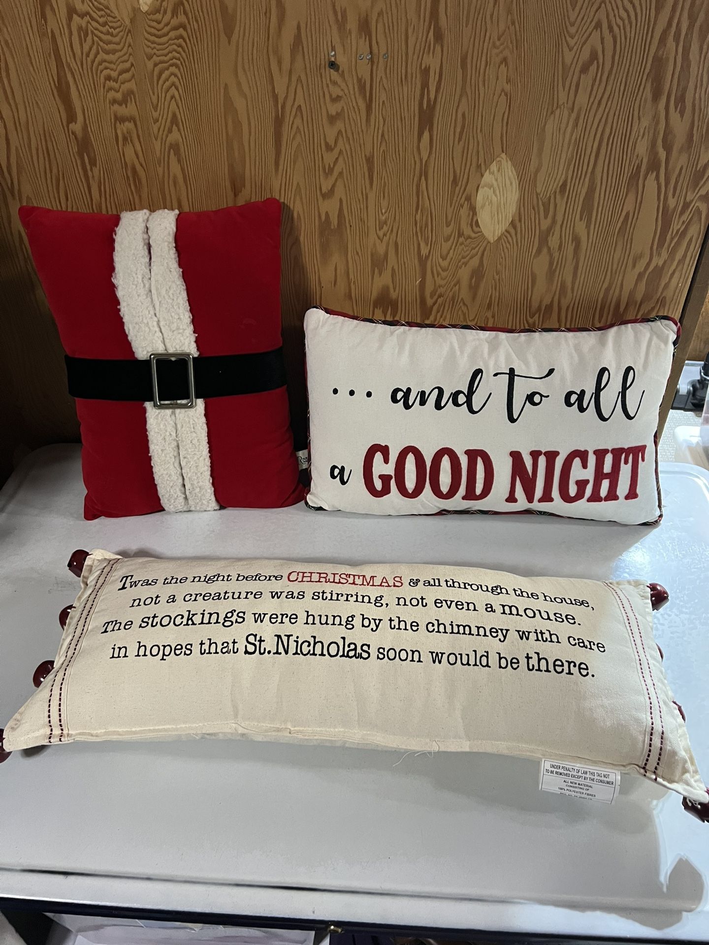 Set of three Christmas-themed decorative throw pillows festive designs and quotes.