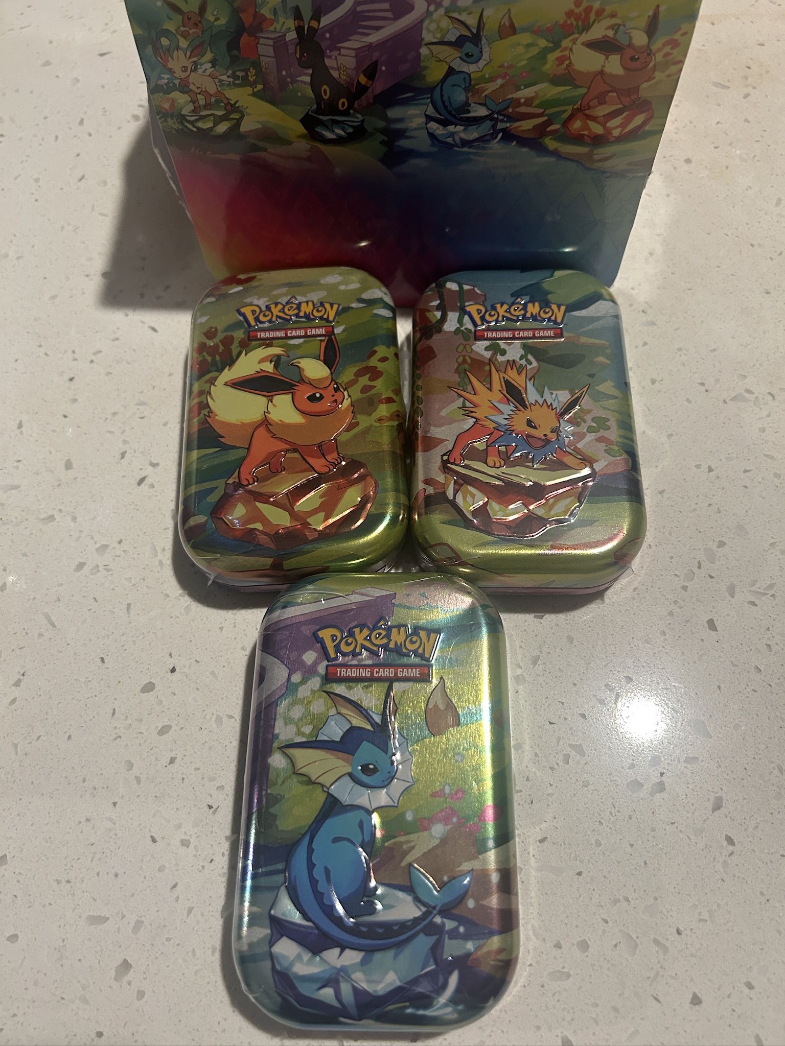 Prismatic Evolution Tins