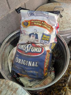 Charcoal briquettes in metal trash cans