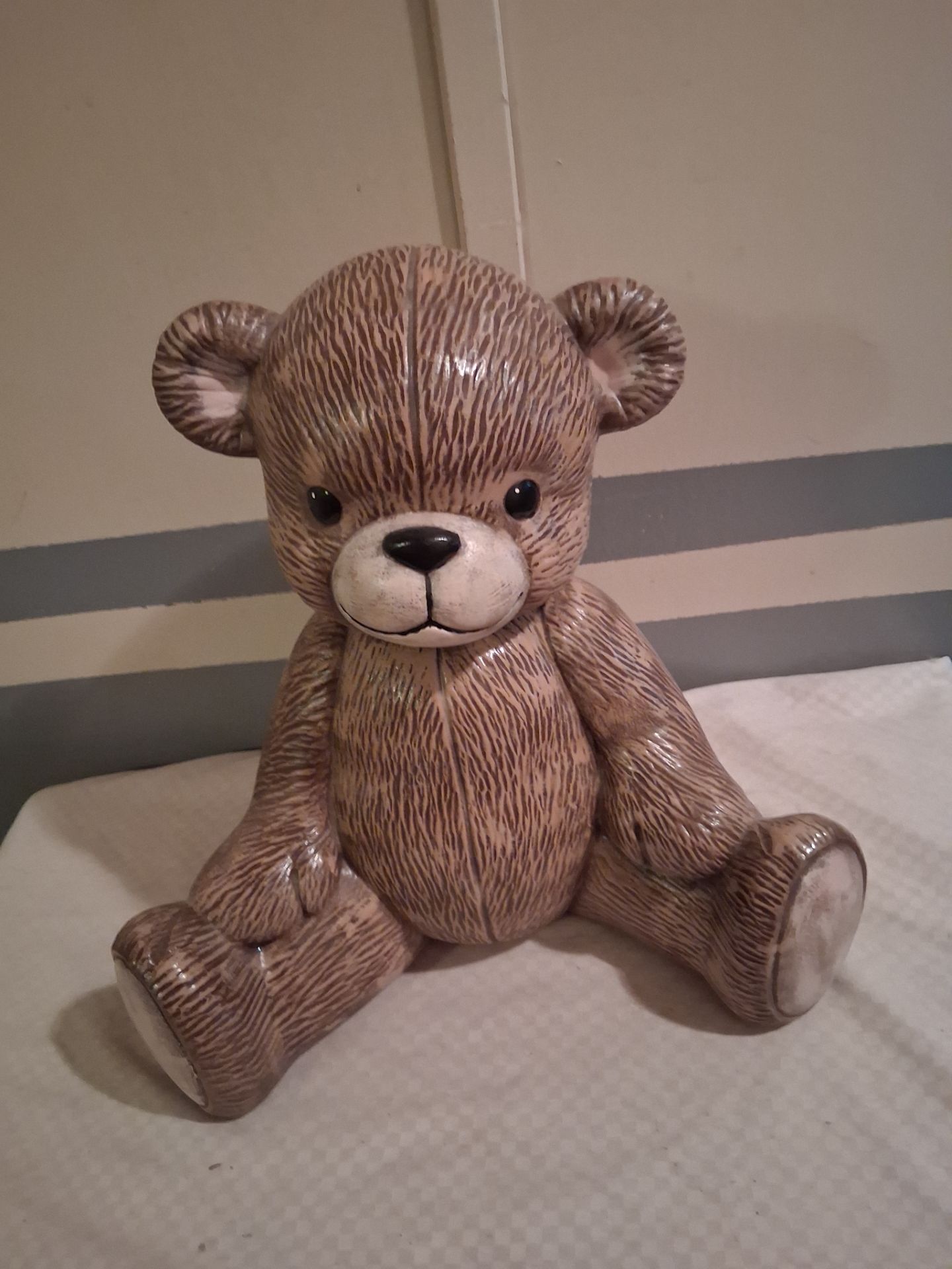 Vintage ceramic teddy bear in the sitting position likely from the 1980s or 1990s featuring a textured brown finish