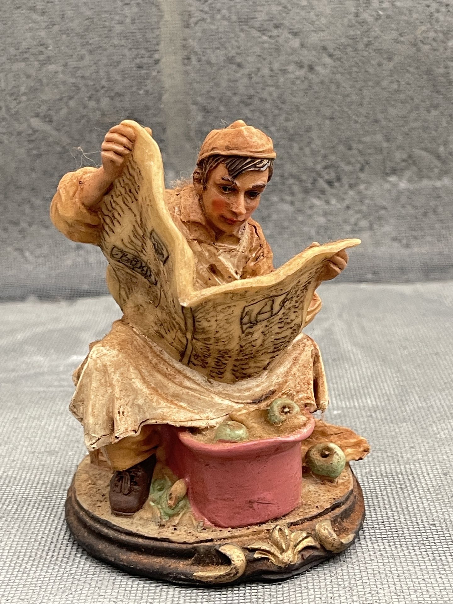 Vintage Resin Figure Sitting on Crate Working with Apples, Reading a Newspaper