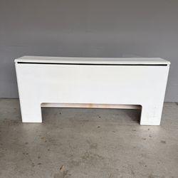 A long white table. White table for the living room