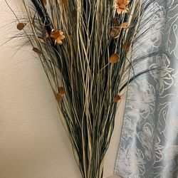 Tall decorative dried grass bundle with flowers