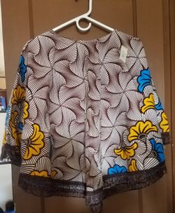 African fabric cape with fringes at the bottom. Medium to large can wear it.