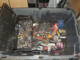 Tub with assorted tools pipe wrenches ratchets sockets pliers