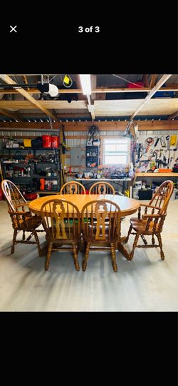 Oak pedestal dining table with six chairs