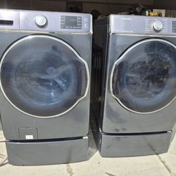 Dark stainless Samsung washer and gas dryer set with pedestals
