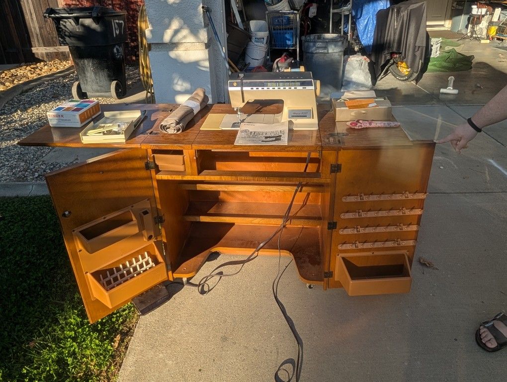 Singer Athena 2000 Sewing Machine and Cabinet with manual and accessories.