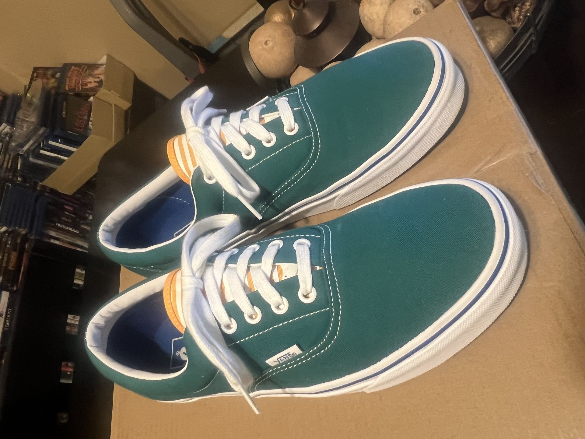 Vans Era sneakers in a teal blue/green canvas color