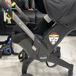 Doona Stroller Original and doona snap on storage accessory black  original price $600 from Dillard expire 2029