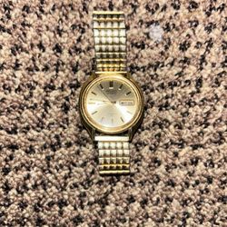 This item is a vintage Seiko 5 Automatic watch, often featuring a gold-toned finish and a day-date complication