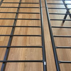 Futon base is of metal and the hand rests are of solid wood