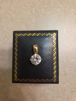14 k gold pendant with cz.  Weight is 2.6 grams