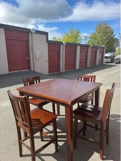 Square wooden high table and four chairs