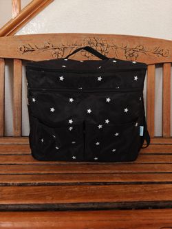 Diaper bag attaches to carrier.