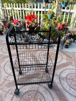 Sturdy metal food/utility cart on wheels with 3 compartments; measures 28 inches high, 13 inches wide, and 17 inches long