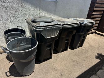 5 trash cans 1 wheel barrow