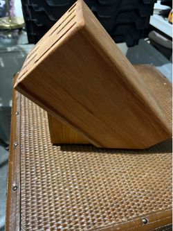 This vintage wooden knife block likely provides storage for several knives and a sharpening steel.