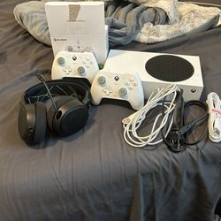 xbox series s with two wired controllers and a headset wireless 