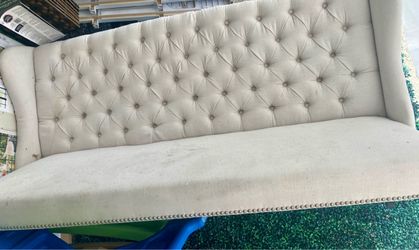 tufted wingback bench, often referred to as an upholstered dining settee or banquette bench