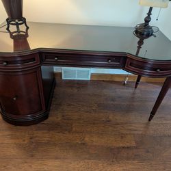 executive style wooden desk with glass top