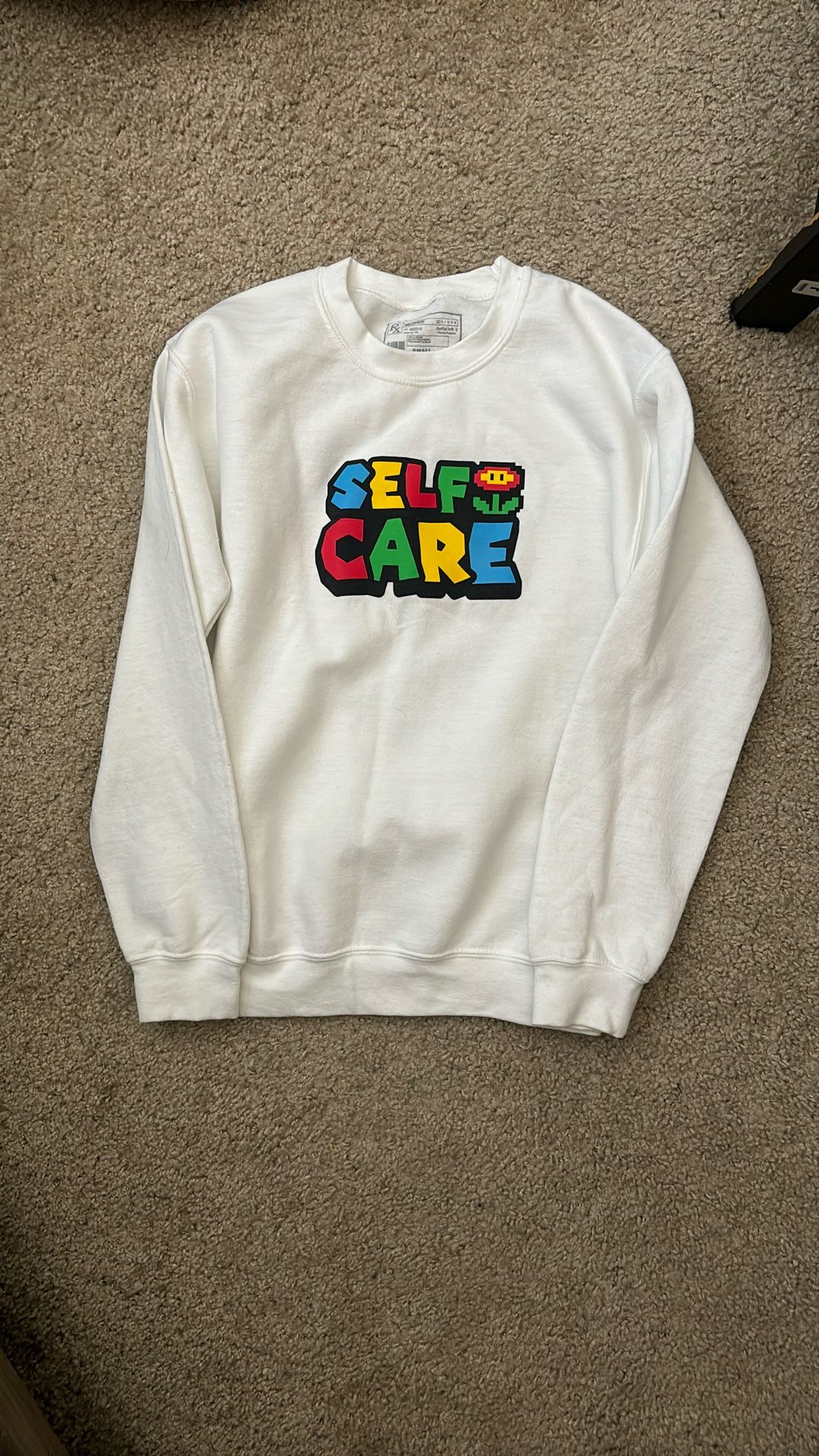 White Sweatshirt with Colorful 'Self Care' Graphic