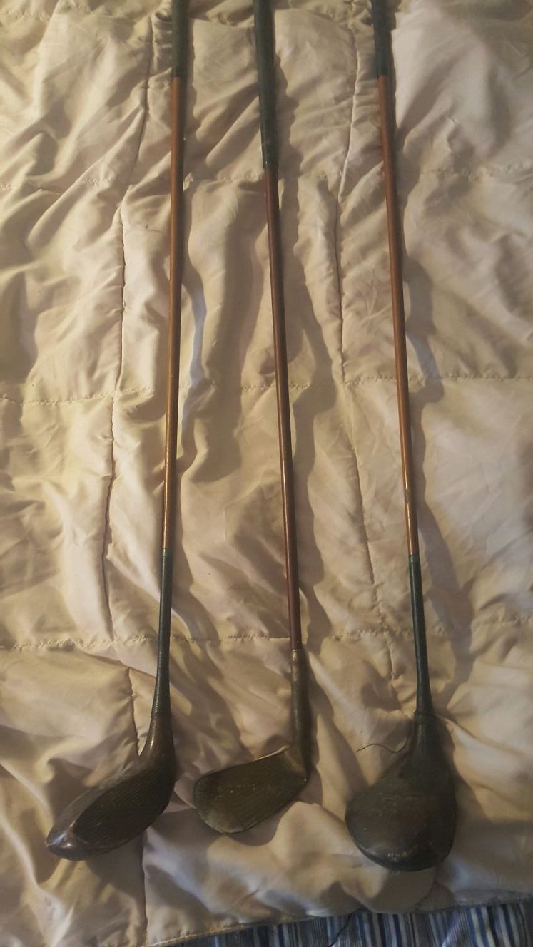 Set of 3 old golf clubs.