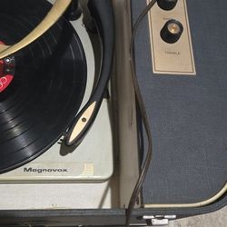 vintage Magnavox Micromatic portable record player, specifically a stereo unit often featuring fold-out speakers and a record changer capable of playi