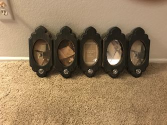 Picture frame with hangers. Holds 5 photos