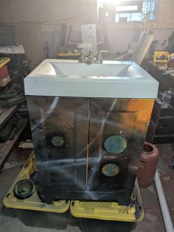 Bathroom vanity with sink and faucet.