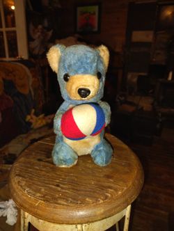 collectible plush item, similar to teddy bears crafted by manufacturers like the Vermont Teddy Bear Company or Charlie Bears. 1960s.