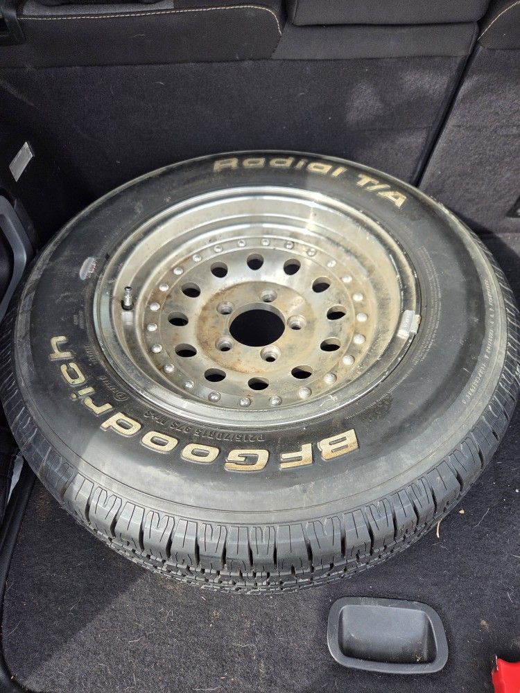 Set of 3 trailer rims and 1 tire.